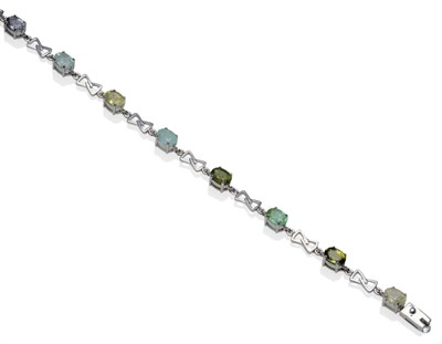 Lot 1222 - An 18 Carat White Gold Tourmaline Bracelet, assorted oval cut tourmalines of green hues in...
