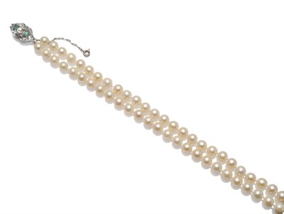 Lot 1247 - A Cultured Pearl Two Row Necklace, the graduated pearls knotted to a bow shaped clasp set with...
