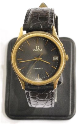 Lot 1252 - A 9ct Gold Calendar Centre Seconds Wristwatch, signed Omega, circa 1980, quartz movement, black...
