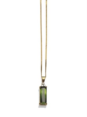 Lot 1258 - An 18 Carat Gold Green Tourmaline and Diamond Pendant on Chain, the long baguette cut green...