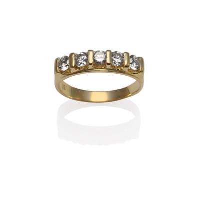Lot 1260 - A Diamond Five Stone Ring, the round brilliant cut diamonds in yellow bar settings, on a plain...
