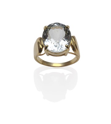 Lot 1266 - An 18 Carat Gold Aquamarine Solitaire Ring, the oval cut aquamarine in a yellow claw setting,...