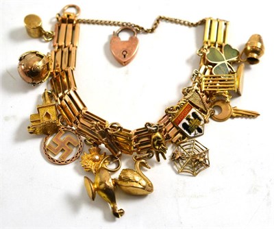 Lot 1269 - A Gate Bracelet, hung with seventeen assorted charms including a swan, a Masonic ball, a...