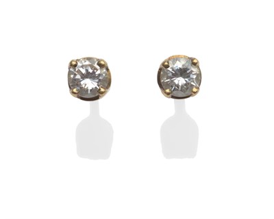 Lot 2014 - A Pair of 18 Carat Gold Diamond Solitaire Stud Earrings, the round brilliant cut diamonds in yellow