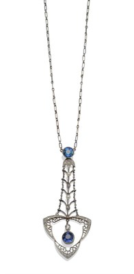 Lot 2023 - A Sapphire, Diamond and Seed Pearl Set Pendant, the stone set drop on a white trace link chain,...