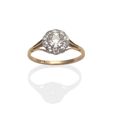 Lot 2024 - A Diamond Cluster Ring, the old cut diamonds in white claw and collet settings, to a yellow...
