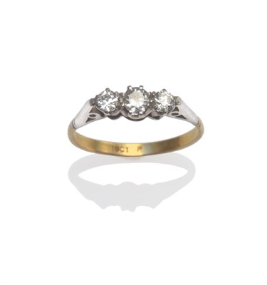 Lot 2029 - A Diamond Three Stone Ring, circa 1930, the graduated old cut diamonds in white claw settings,...