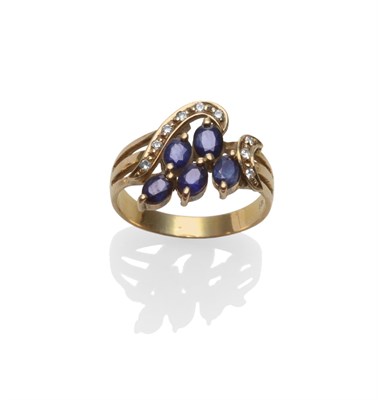 Lot 2066 - A Sapphire and Diamond Spray Ring, oval cut sapphires in yellow claw settings in a spray form, to a
