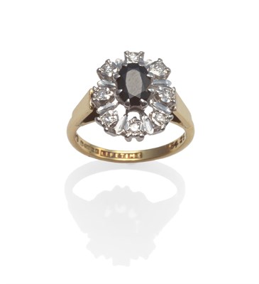 Lot 2077 - An 18 Carat Gold Sapphire and Diamond Cluster Ring, an oval cut sapphire within a spaced border...