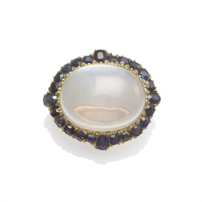 Lot 2083 - A Moonstone and Sapphire Cluster Brooch, a cabochon moonstone within a border of oval cut...