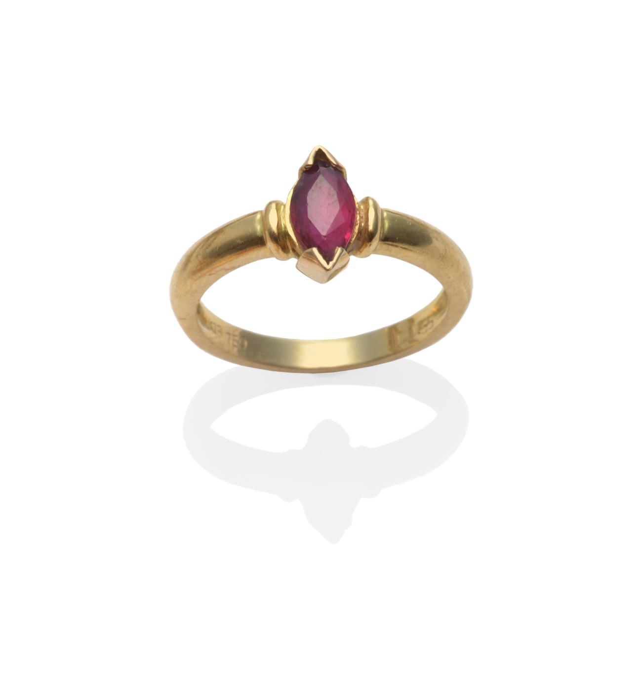 Lot 2092 - A Ruby Solitaire Ring, a marquise cut ruby in a yellow claw setting on a plain polished shank,...