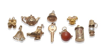 Lot 2093 - Ten 9 Carat Gold Charms, including a key, a fortune teller in a caravan, a cornelian ball, a 10...