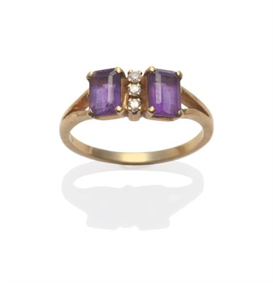 Lot 2098 - An Amethyst and Diamond Ring, two emerald-cut amethysts separated by a row of three round brilliant