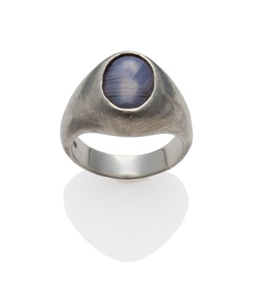Lot 2130 - A Star Sapphire Ring, the oval cabochon sapphire within a white polished mount, finger size U1/2