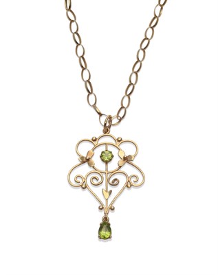 Lot 2144 - An Edwardian Style Pendant, the scrolling design set with two peridots, measures 3.1cm by 5.1cm, on