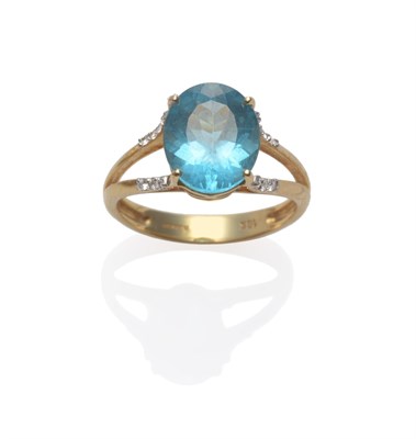 Lot 2149 - An 18 Carat Gold Blue Topaz and Diamond Ring, the oval cut blue topaz in a yellow four claw...