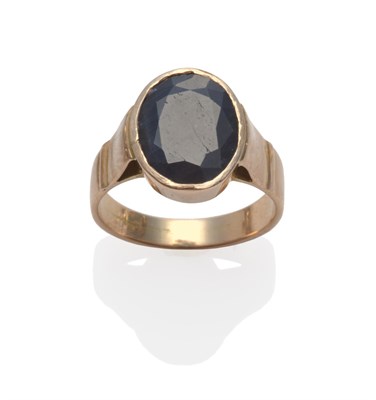 Lot 2151 - A Sapphire Ring, the oval mixed cut sapphire in a yellow collet setting, on a plain polished shank