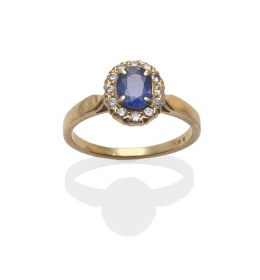 Lot 2154 - A Sapphire and Diamond Cluster Ring, the oval cut sapphire within a border of round brilliant...