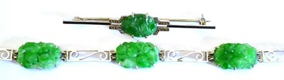 Lot 2157 - A Jade Bracelet, comprising five carved plaques, alternating with white scroll panel links,...