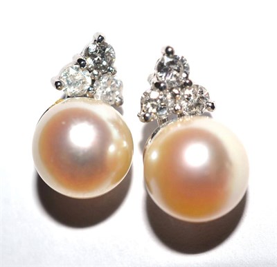 Lot 2158 - A Pair of 18 Carat White Gold Cultured Pearl and Diamond Earrings, a trio of round brilliant...