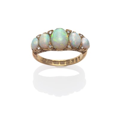 Lot 2170 - An 18 Carat Gold Opal Ring, the five graduated cabochon opals spaced by pairs of tiny diamonds,...