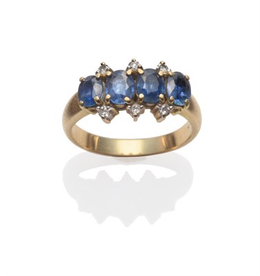 Lot 2173 - A Sapphire and Diamond Ring, four oval cut sapphires with diamond accents, in white and yellow claw