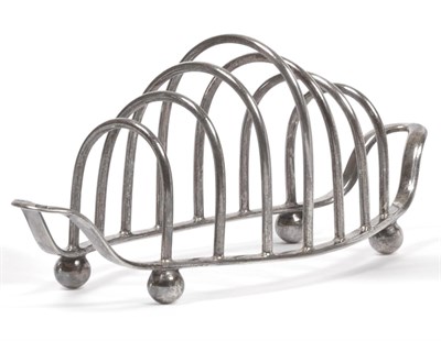 Lot 2219 - A George V Silver Toast Rack, William Lister & Sons, Sheffield 1935, oval with upturned ends...