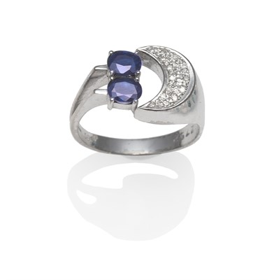 Lot 2014 - A Sapphire and Diamond Ring, two oval cut sapphires to a pavé set diamond crescent shape, on a...