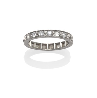 Lot 2018 - A Diamond Eternity Ring, set with old cut and eight-cut diamonds, in white claw settings to a...