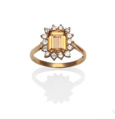 Lot 2024 - A Topaz and Diamond Cluster Ring, an emerald-cut topaz within a border of round brilliant cut...