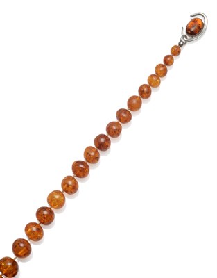 Lot 2026 - An Amber Necklace, of graduated beads with sun spangled effect, knotted to a contemporary...