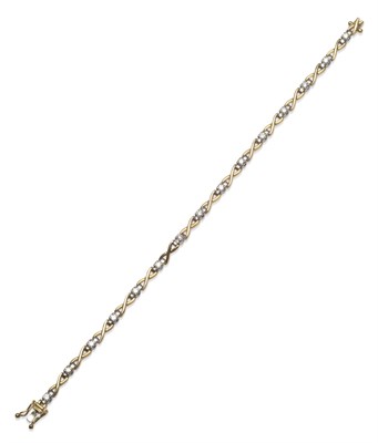 Lot 2028 - An 18 Carat Gold Diamond Bracelet, yellow crossover links alternate with round brilliant cut...