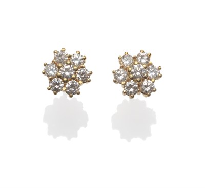 Lot 2032 - A Pair of Diamond Cluster Earrings, each set with seven round brilliant cut diamonds in yellow claw