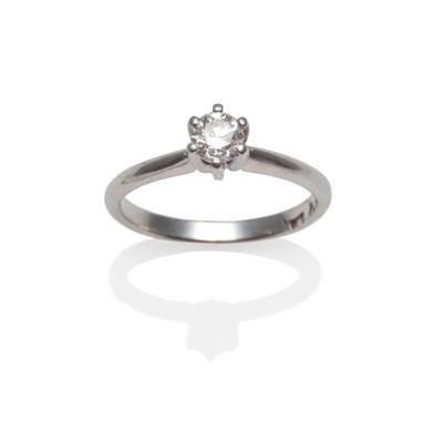 Lot 2038 - A Diamond Solitaire Ring, the round brilliant cut diamond in a white six claw setting, to...