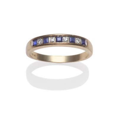 Lot 2043 - A 9 Carat Gold Sapphire and Diamond Half Hoop Ring, square step cut sapphires alternate with...