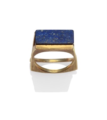 Lot 2064 - A Lapis Lazuli Ring, an oblong panel of lapis lazuli on a contemporary textured and shaped...