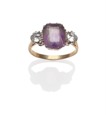 Lot 2073 - An Amethyst and Diamond Three Stone Ring, the cushion cut amethyst between two round brilliant...