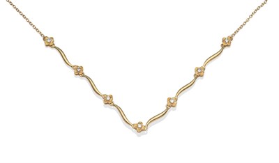 Lot 2079 - An 18 Carat Gold Diamond Necklace, diamond set floral motifs alternate with wavy polished links, on