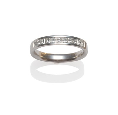 Lot 2089 - An 18 Carat White Gold Half Hoop Ring, princess cut diamonds channel set, on a plain polished...