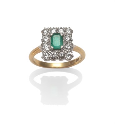 Lot 2091 - An Emerald and Diamond Cluster Ring, a step-cut emerald within a border of round brilliant cut...