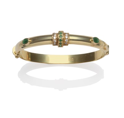 Lot 2092 - An Emerald and Diamond Bangle, rows of round cut emeralds and round brilliant cut diamonds to...