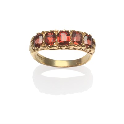 Lot 2100 - An 18 Carat Gold Garnet Five Stone Ring, the graduated cushion cut garnets in yellow claw...