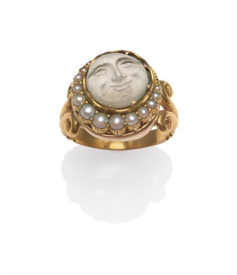 Lot 2111 - A Faux Moonstone and Seed Pearl Ring, the moonstone simulant carved as 'the man in the moon',...