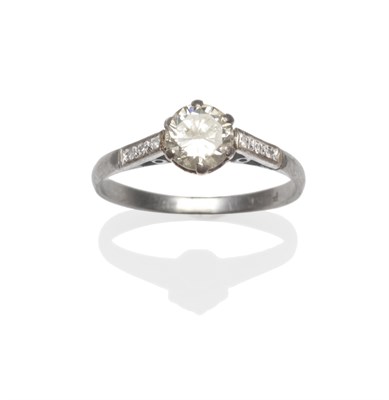 Lot 2120 - A Diamond Solitaire Ring, a round brilliant cut diamond in a white claw setting to diamond set...