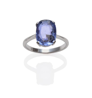 Lot 2130 - A Sapphire Solitaire Ring, the cushion cut sapphire in a white four claw setting on a tapered...