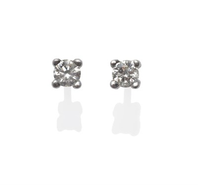 Lot 2136 - A Pair of Diamond Solitaire Stud Earrings, the round brilliant cut diamonds in white claw settings