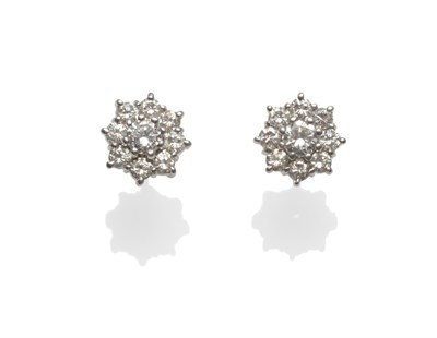 Lot 2140 - A Pair of Diamond Cluster Earrings, each comprising nine round brilliant cut diamonds in white claw