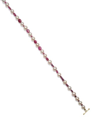 Lot 2147 - A Cultured Pearl Necklace, strung with faceted and cabochon ruby type stones, length 69cm