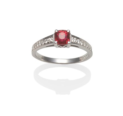 Lot 2148 - A Platinum Ruby and Diamond Ring, the cushion cut ruby in a four claw setting, to shoulders...