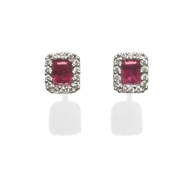 Lot 2154 - A Pair of 18 Carat White Gold Ruby and Diamond Earrings, step cut rubies within a border of...